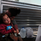 A Honduran child and her mother, fleeing poverty and violence in their home country, waits along the border bridge after being denied entry from Mexico into the U.S. on June 25, 2018 in Brownsville, Texas.